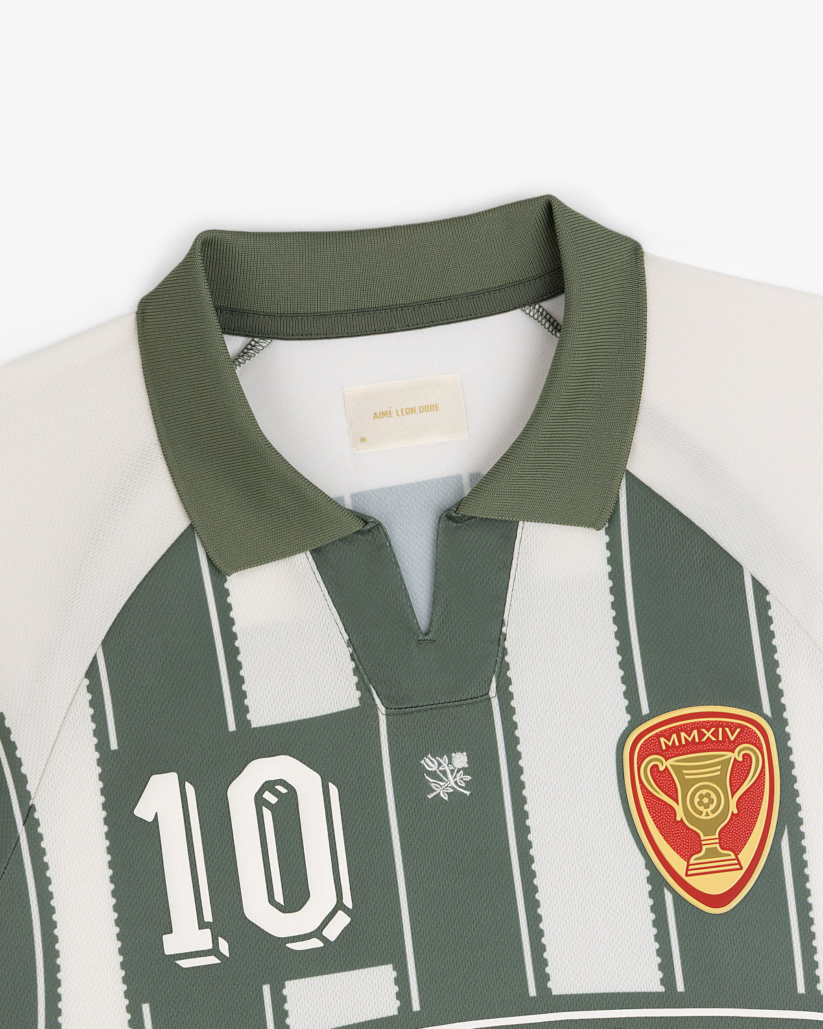 Aimé Cup Soccer Jersey: green/white, number 10, trophy patch, short collar with V-notch.