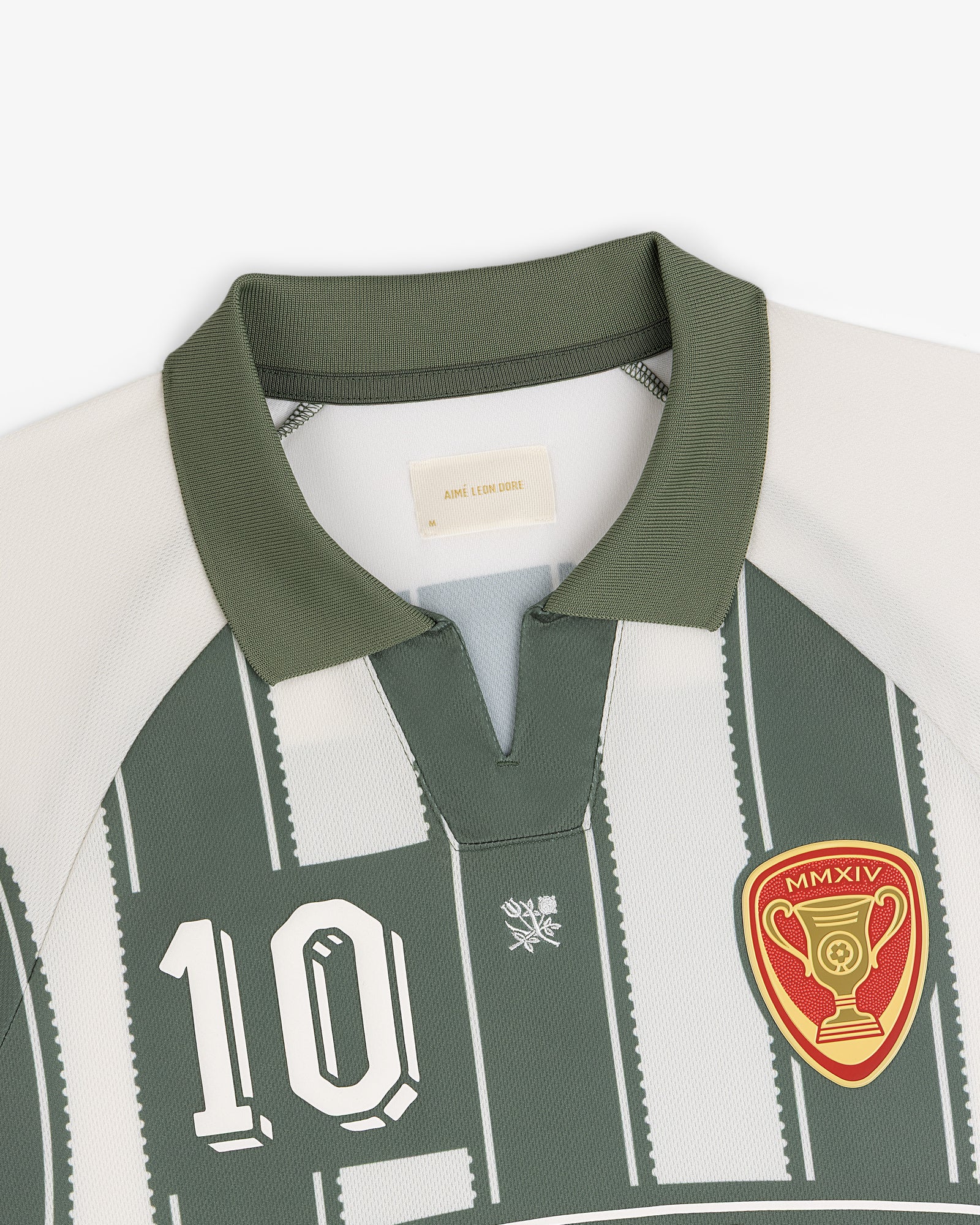 Aimé Cup Soccer Jersey: green/white, number 10, trophy patch, short collar with V-notch.