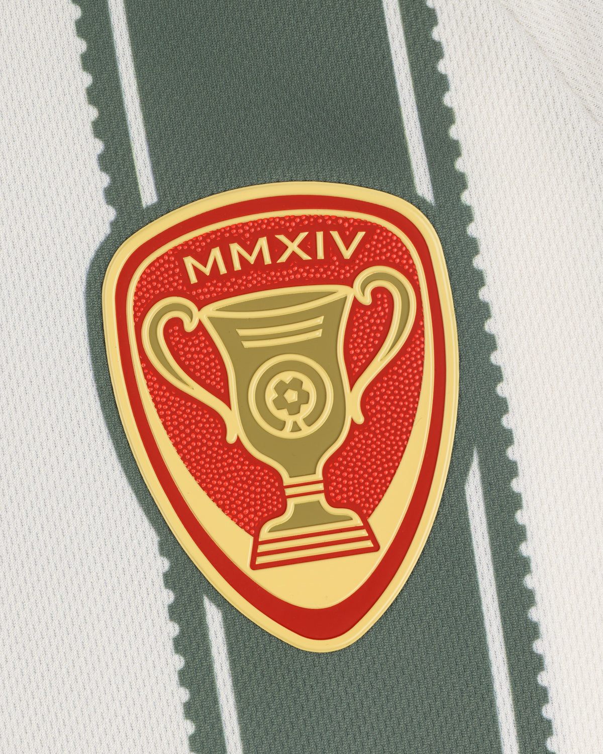 The Aimé Cup Soccer Jersey features a gold and red trophy badge with MMXIV on white and green striped fabric.