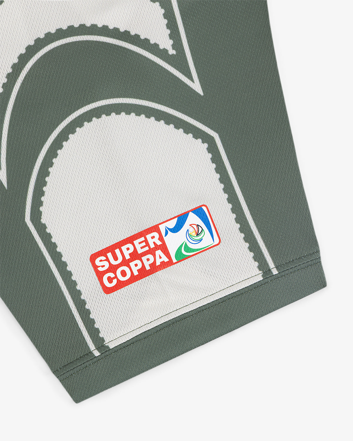 Close-up of the Aimé Cup Soccer Jersey in gray, featuring a Super Coppa patch with a colorful logo on the fabric.