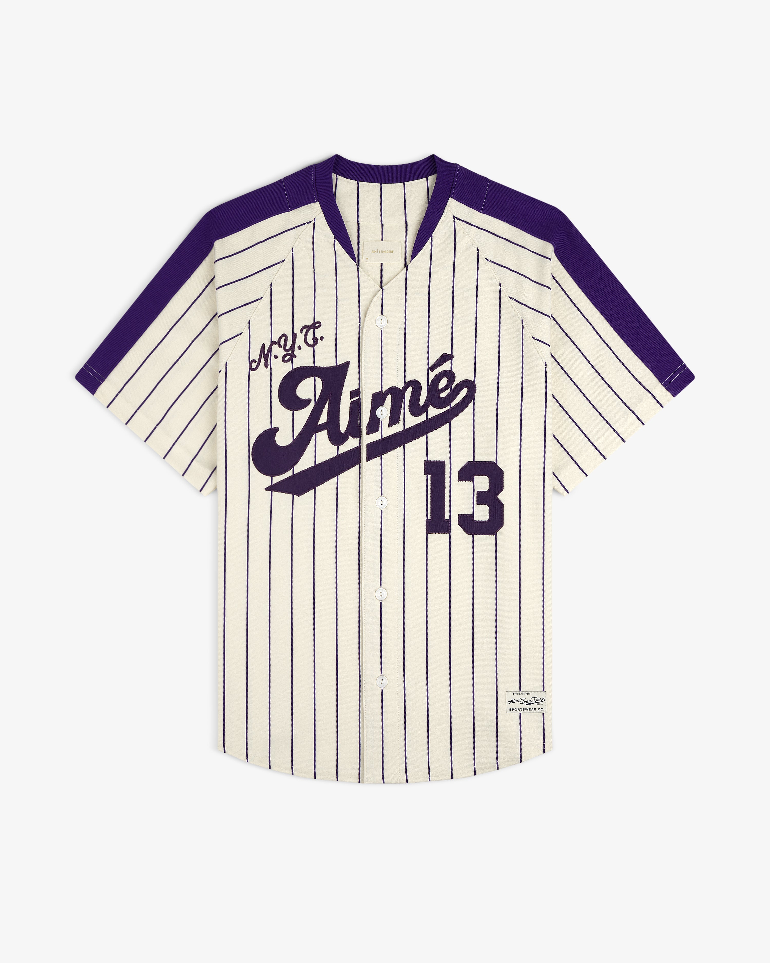 Cream and purple pinstriped Aimé Baseball Jersey with “Aimé” and 13 on the front.