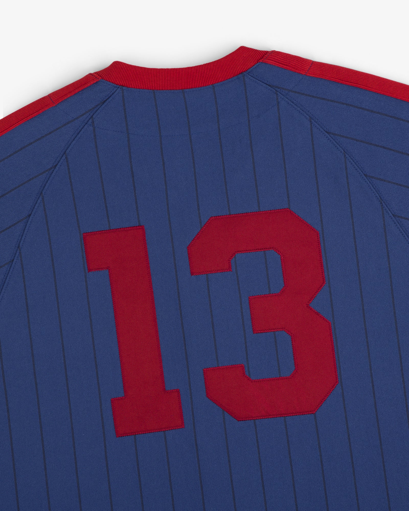 Aimé Baseball Jersey: blue with thin vertical stripes, large red number 13 on the back.