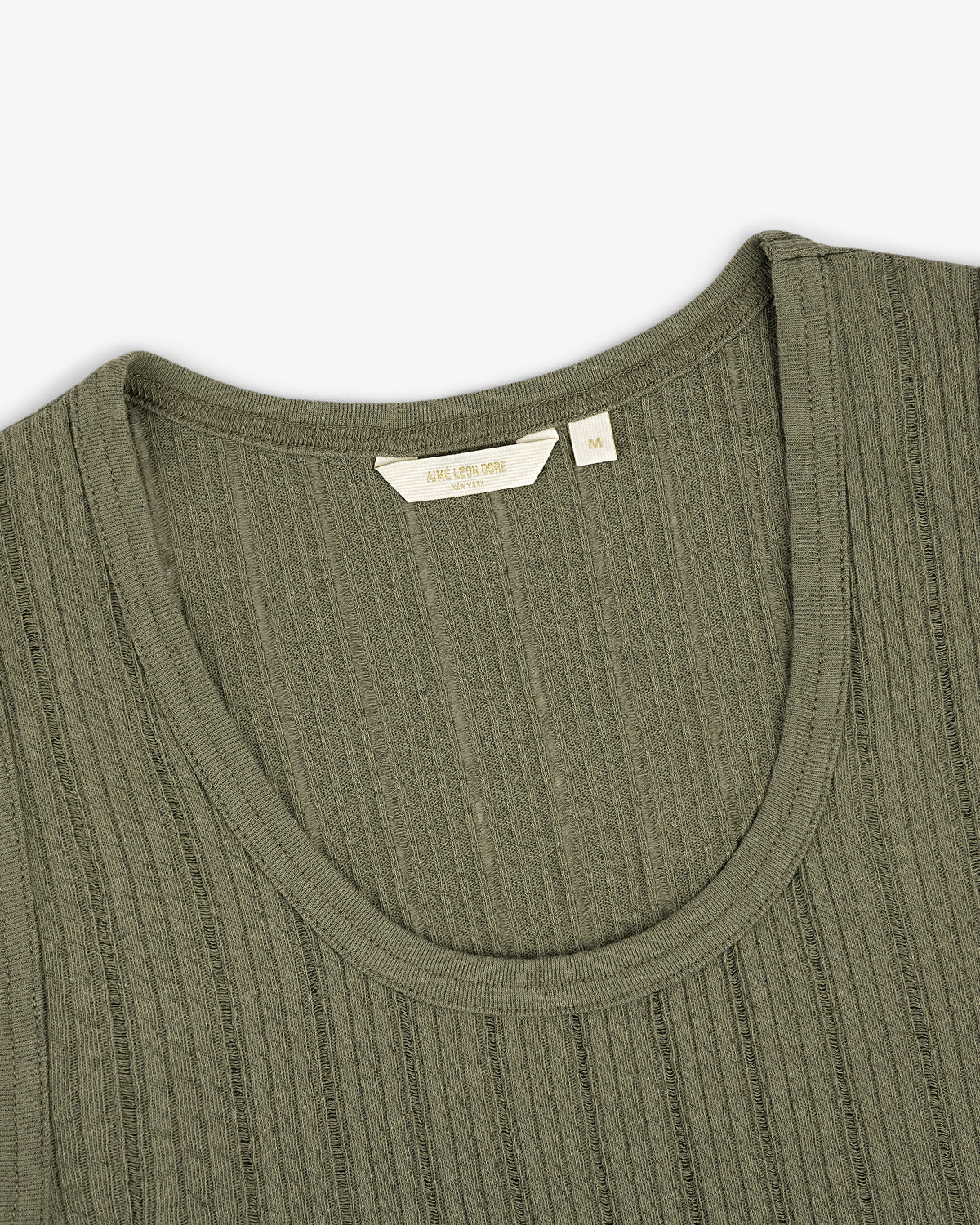 Close-up of the Drop Needle Tank Top in olive green with ribbed knit, round neckline, and visible size tag.