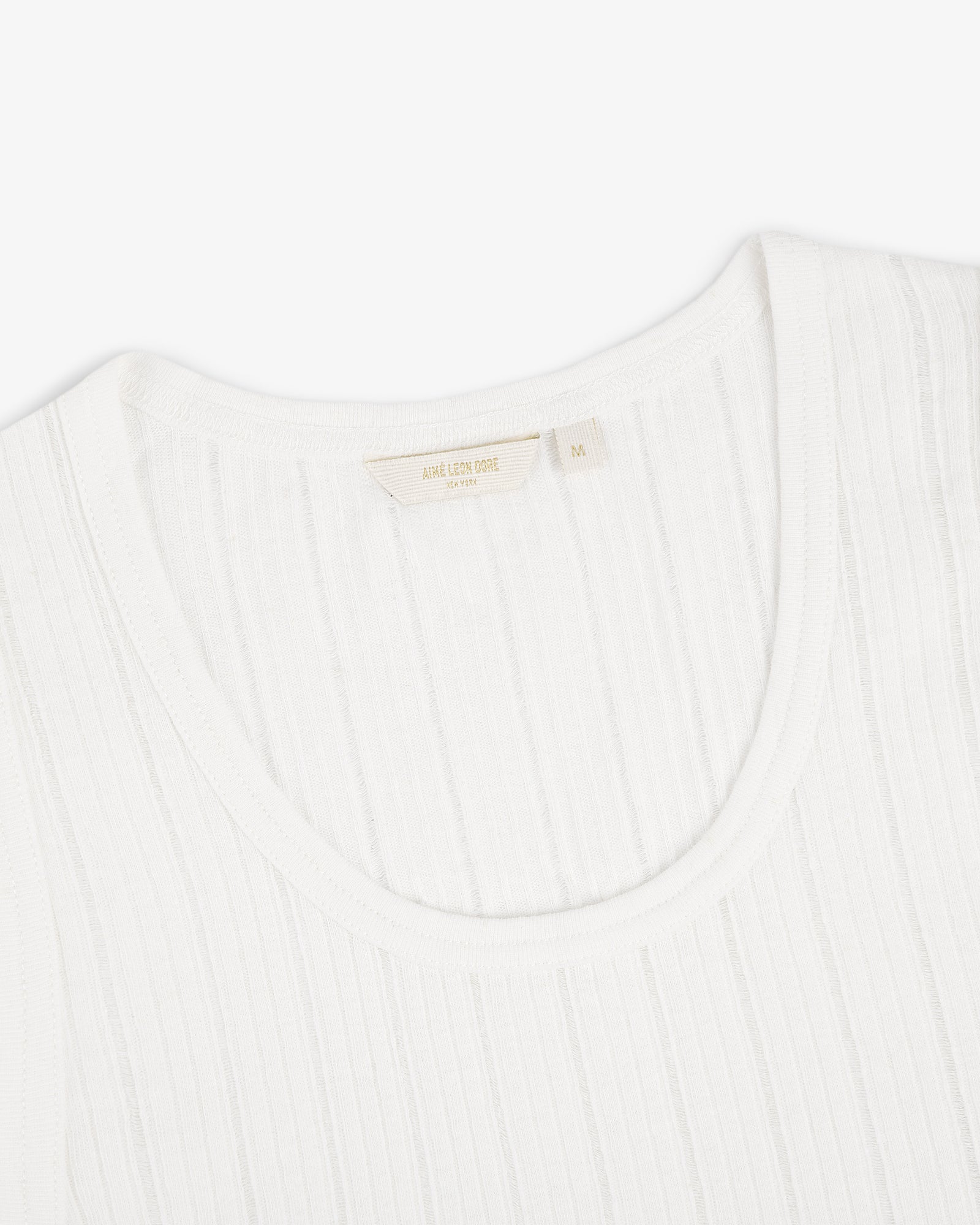Close-up of a Drop Needle Tank Top with a fabric label inside the collar, photographed on a white background.