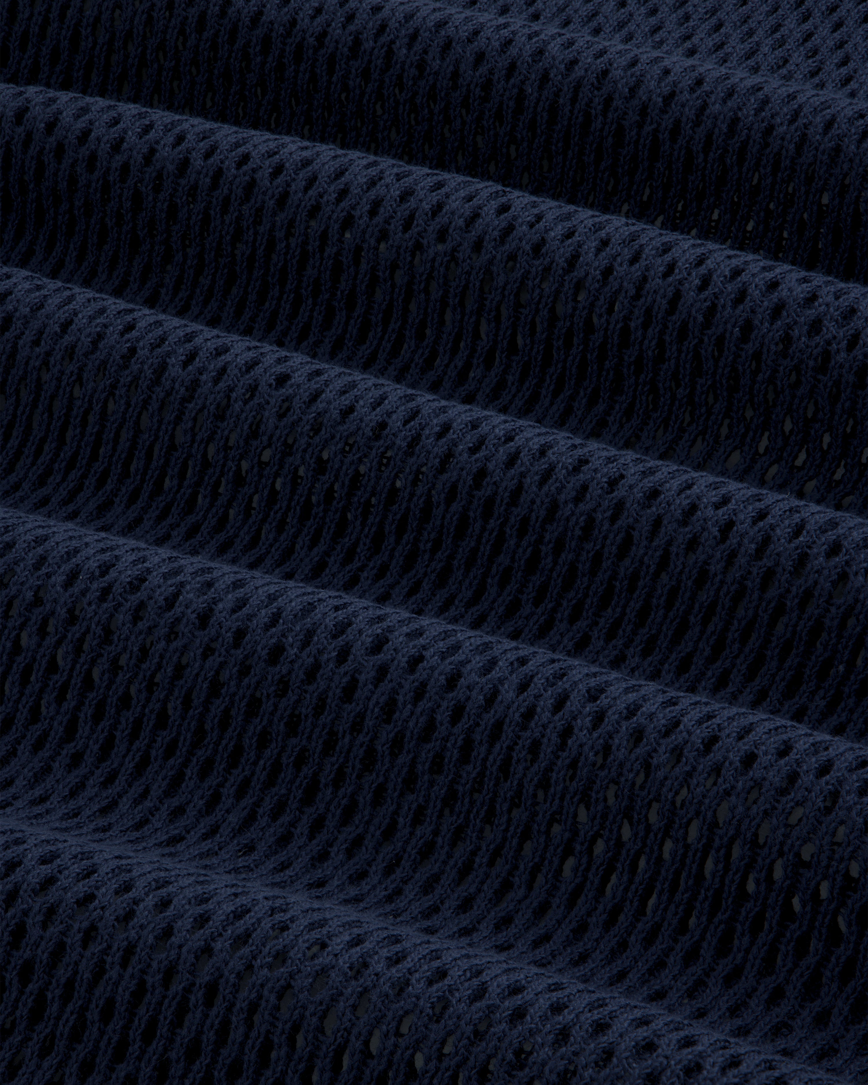 Close-up of dark blue Mesh Tank Top showing textured mesh fabric with small holes and horizontal folds.