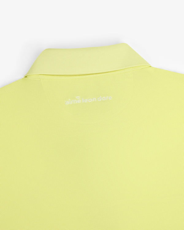 A close-up of the back collar of the light yellow ALD Golf Polo with "alml éean done" printed in white.