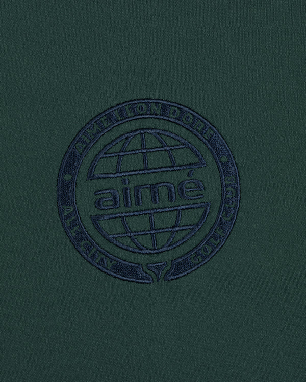 Dark green ALD Golf Tour Polo with a navy globe logo and "Aimé Leon Dore All City Golf Club" circle embroidery.