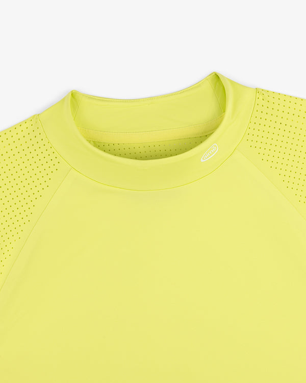Close-up of the ALD Golf Performance Tee in yellow, featuring perforated sleeves and a round neck on white background.