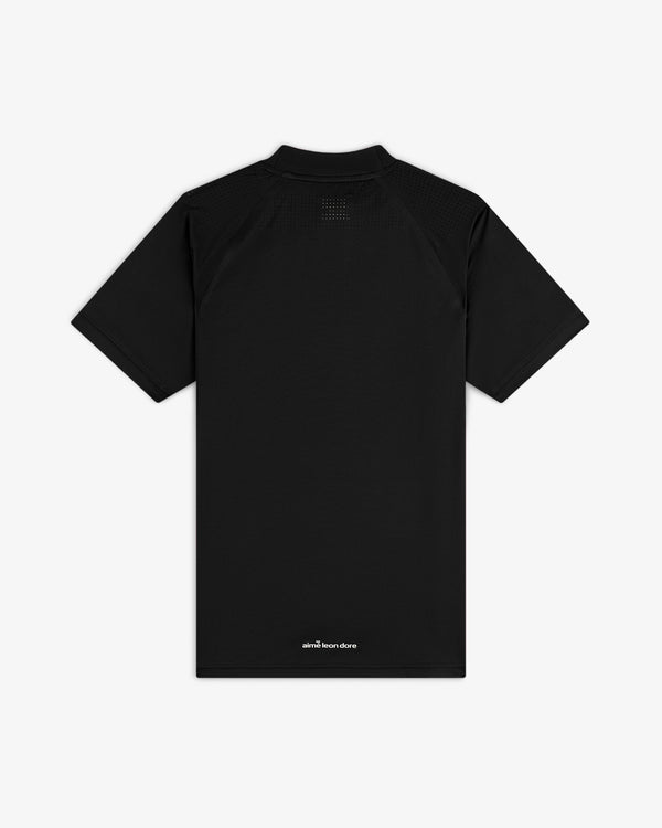 ALD Golf Performance Tee in black, short-sleeve, shown from the back with small white text near the bottom hem.