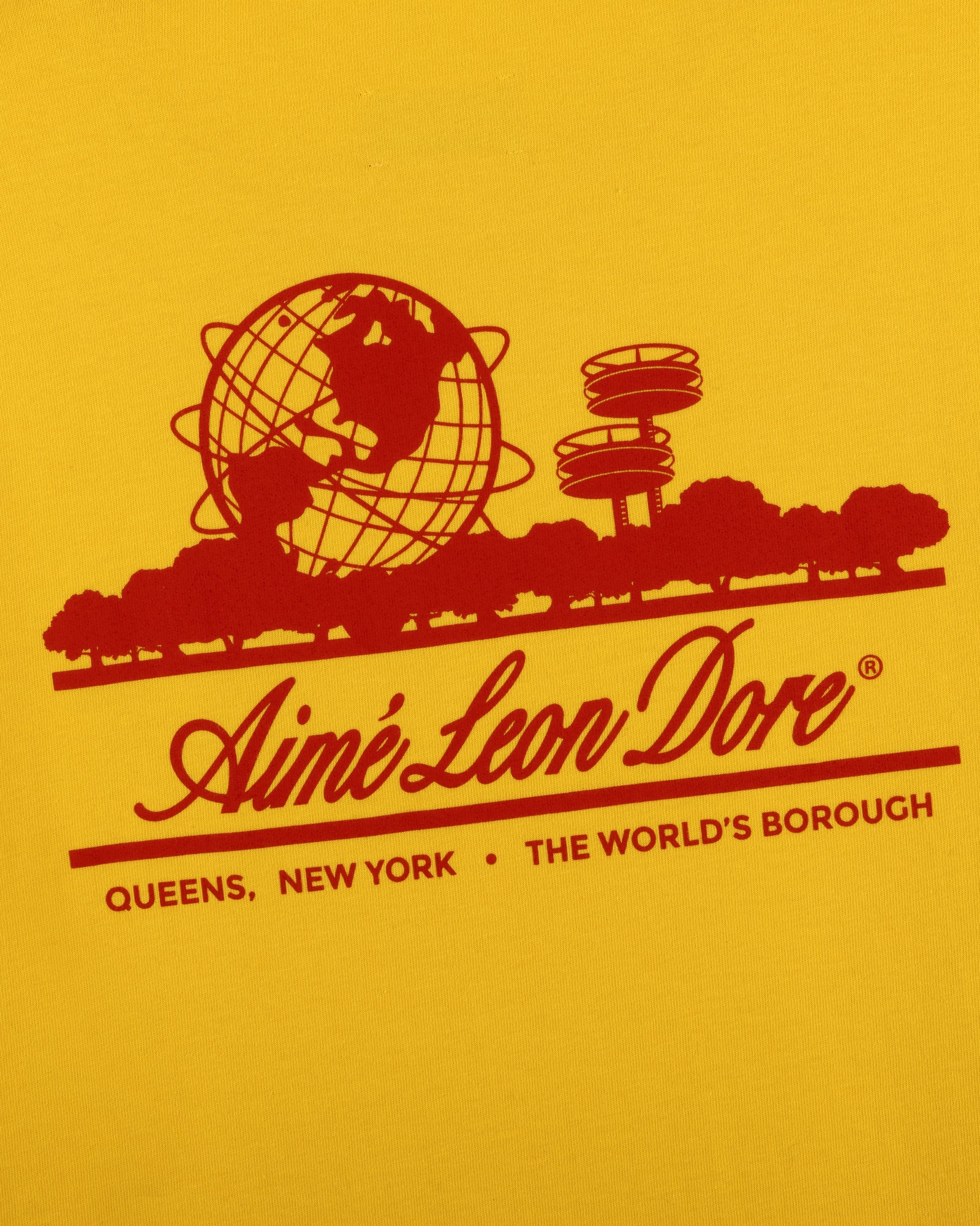Red graphic of globe, trees, Unisphere & text on yellow Sun Faded Unisphere Tee by Aime Leon Dore, Queens, NY.