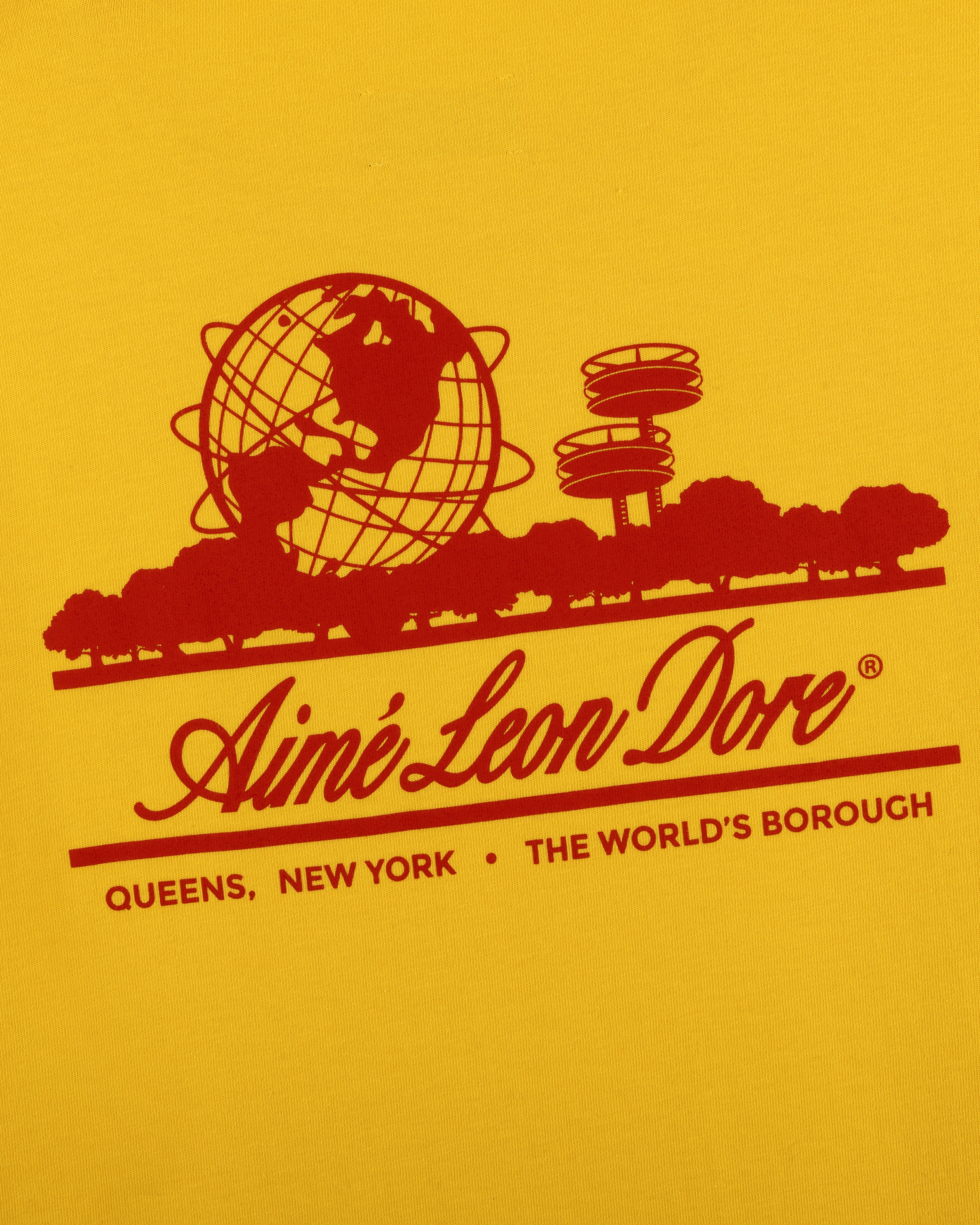 Red graphic of globe, trees, Unisphere & text on yellow Sun Faded Unisphere Tee by Aime Leon Dore, Queens, NY.