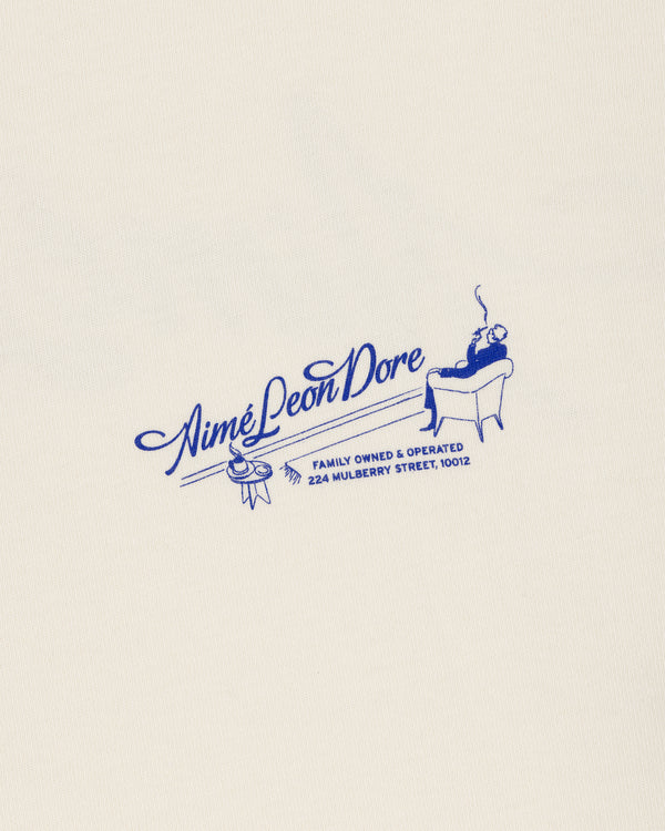 Cream Pappoús Logo Tee with blue Aimé Leon Dore logo, man illustration, and 224 Mulberry Street address.