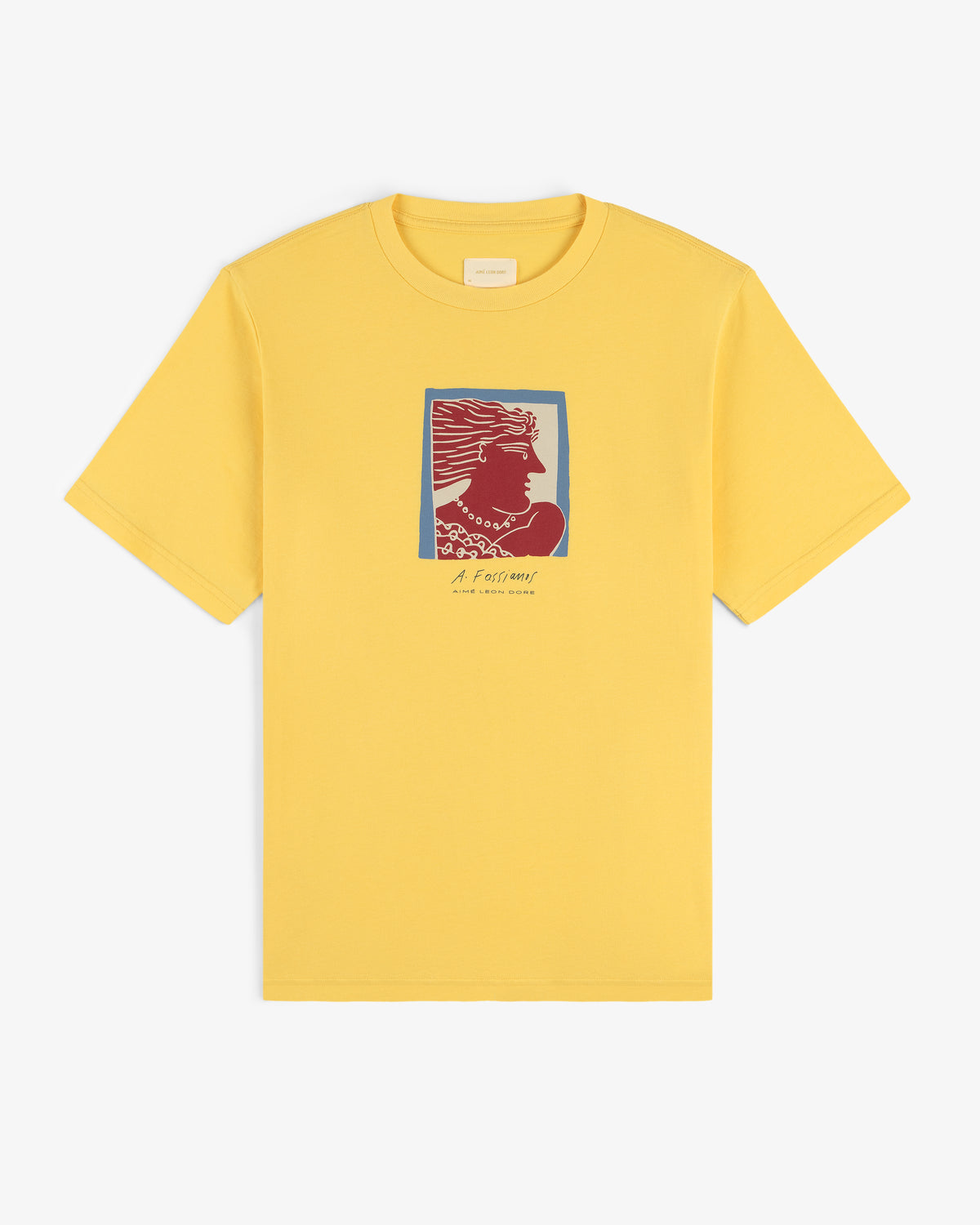 The Fassianos Portrait Tee is a yellow t-shirt featuring a red and blue head graphic with small text below.