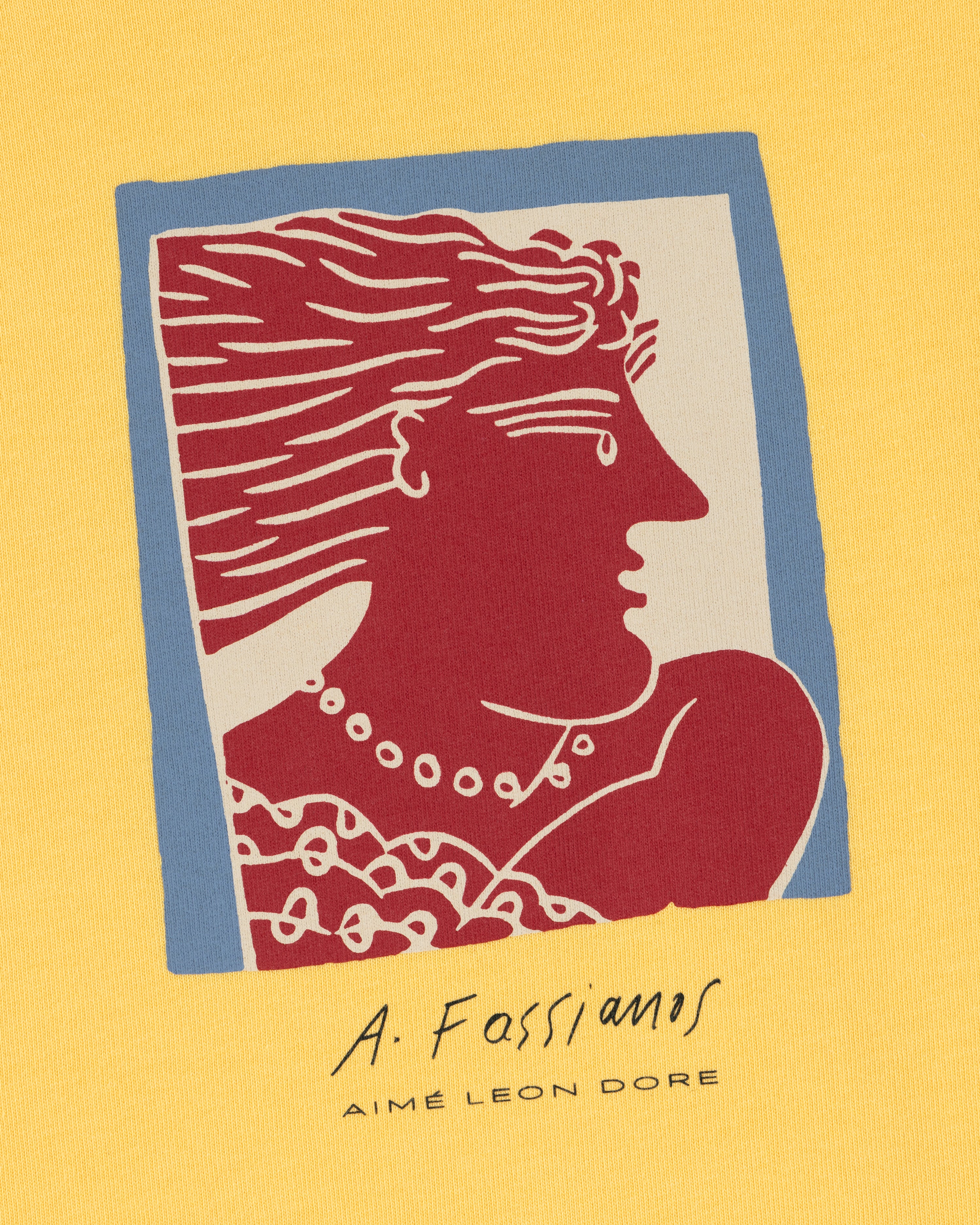 Fassianos Portrait Tee: Red and white profile illustration on yellow with A. Fassianos and AIMÉ LEON DORE text below.