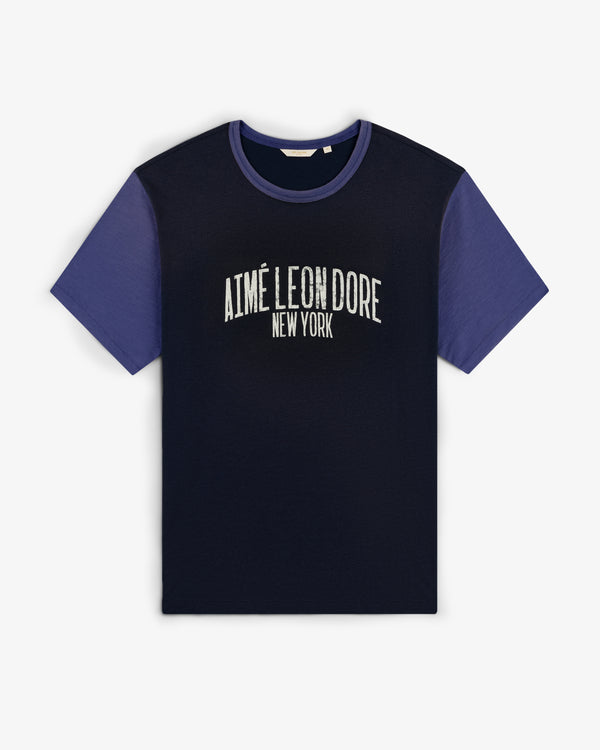 Washed Ringer Tee with dark body, blue sleeves, and AIMÉ LEON DORE NEW YORK text on the front.