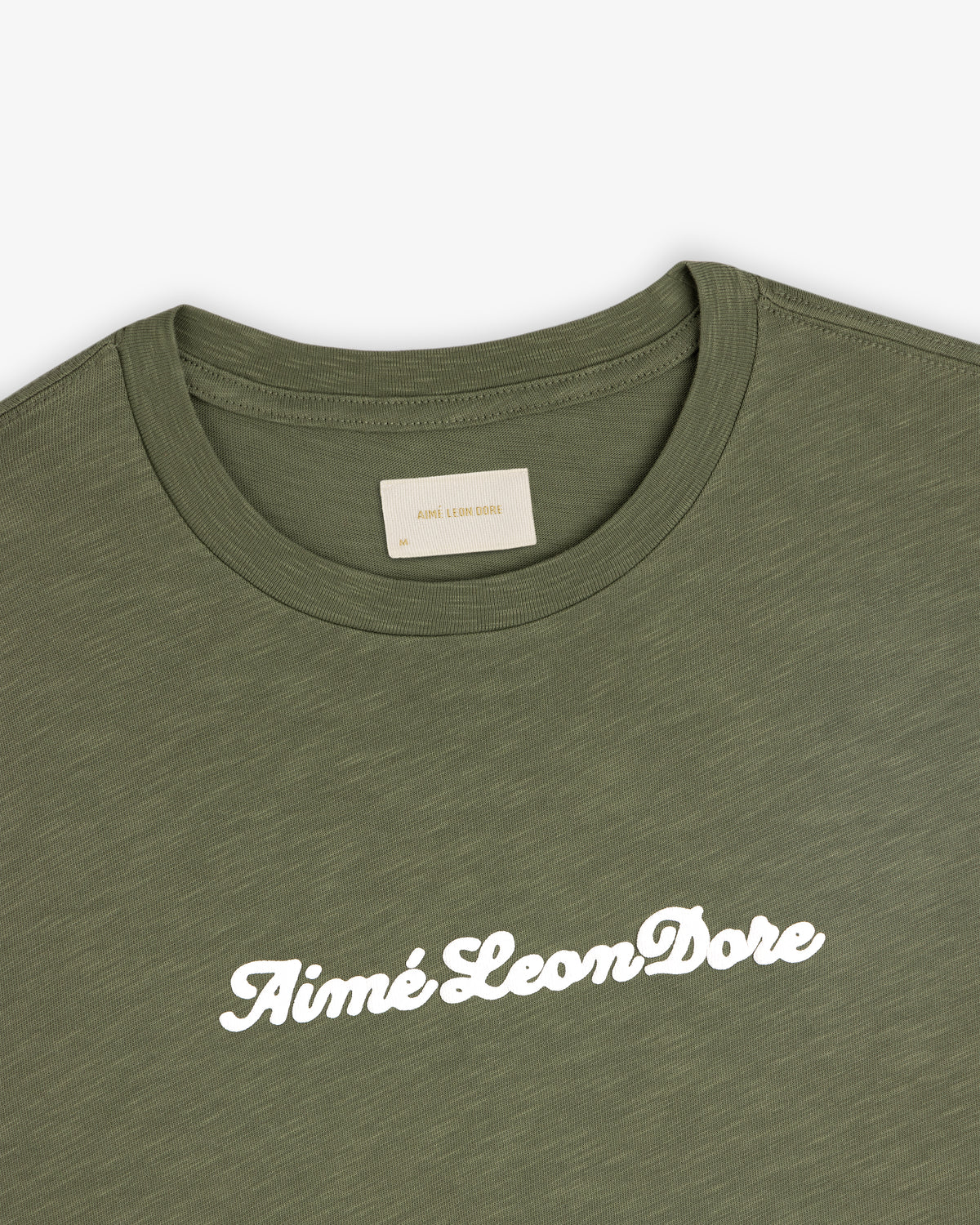 Olive green Puff Print Slub Logo Tee with Aimé Leon Dore in white cursive across the chest.