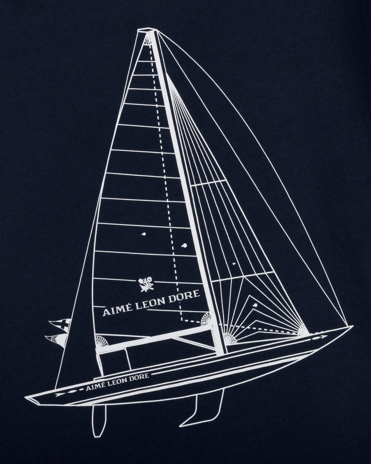 White line sailboat with Aimé Leon Dore text on sail and hull, on dark Marina Tee.