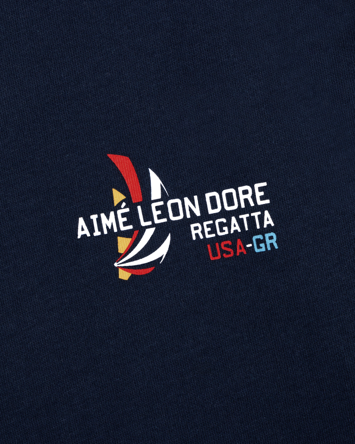 Regatta Tee in navy with AIMÉ LEON DORE REGATTA USA-GR and colorful abstract sailboat graphic print.