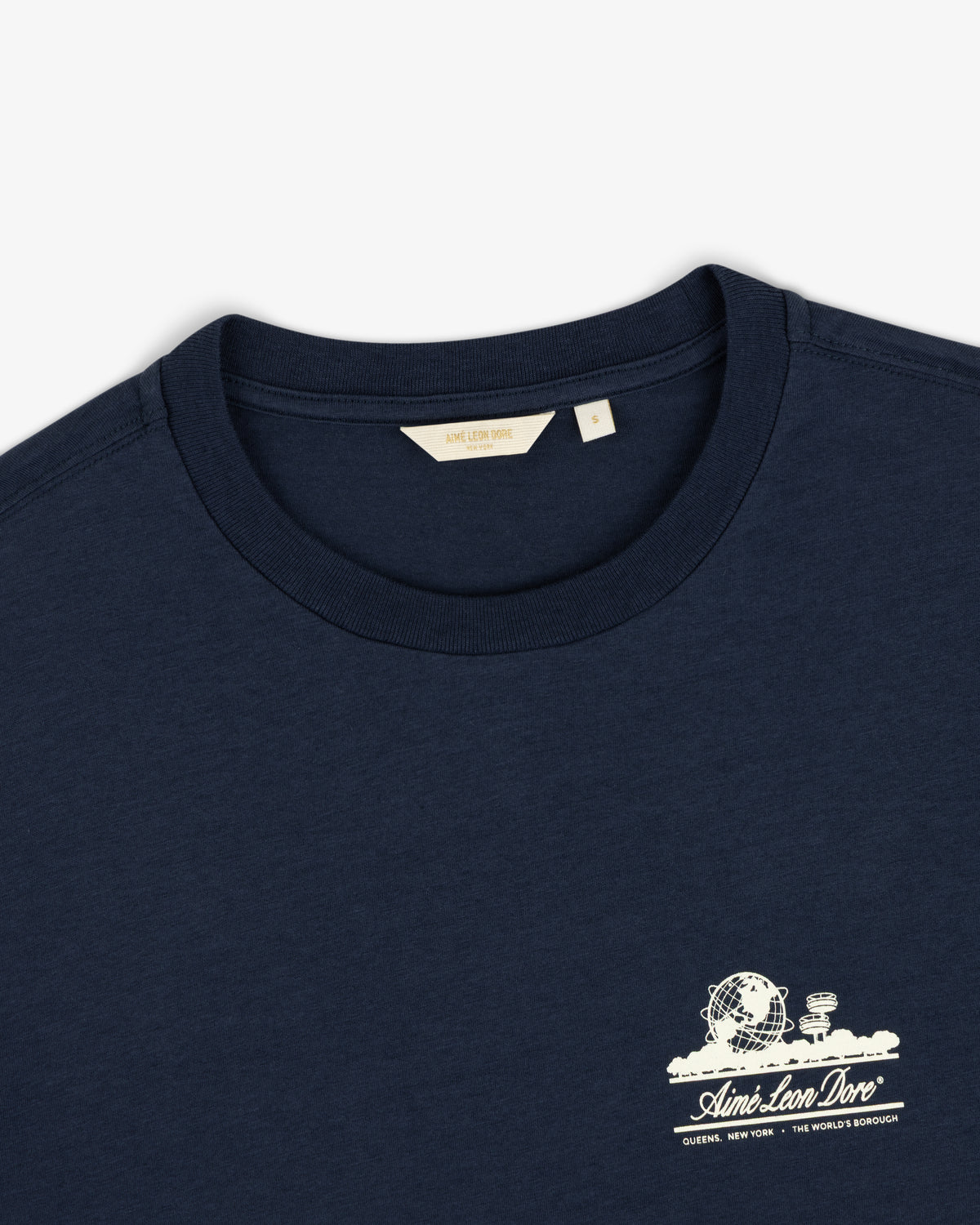 Cropped Aloe-Blend Unisphere Tee in navy blue with a small white graphic and text on the left chest.