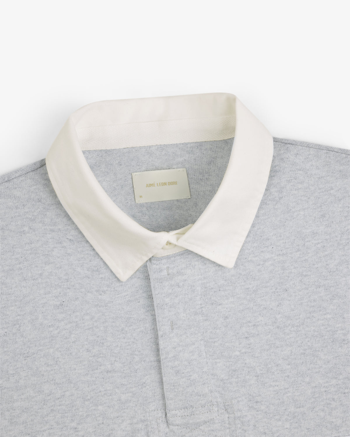 Script Paneled Rugby in light grey with a white collar, shown from the shoulders up on a plain white background.