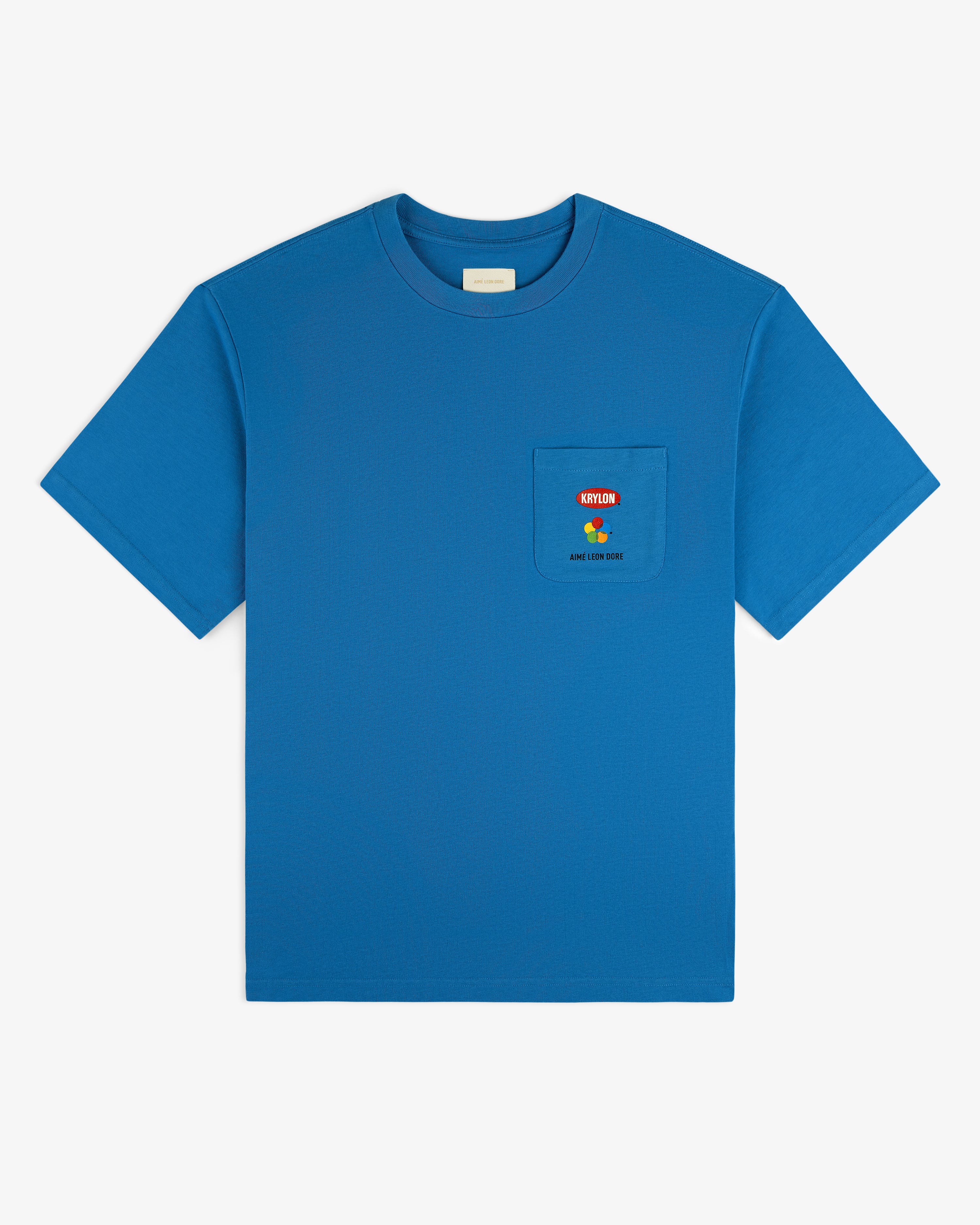 Krylon Pocket Tee: bright blue short-sleeve shirt with chest pocket featuring a small Berlin graphic and text.