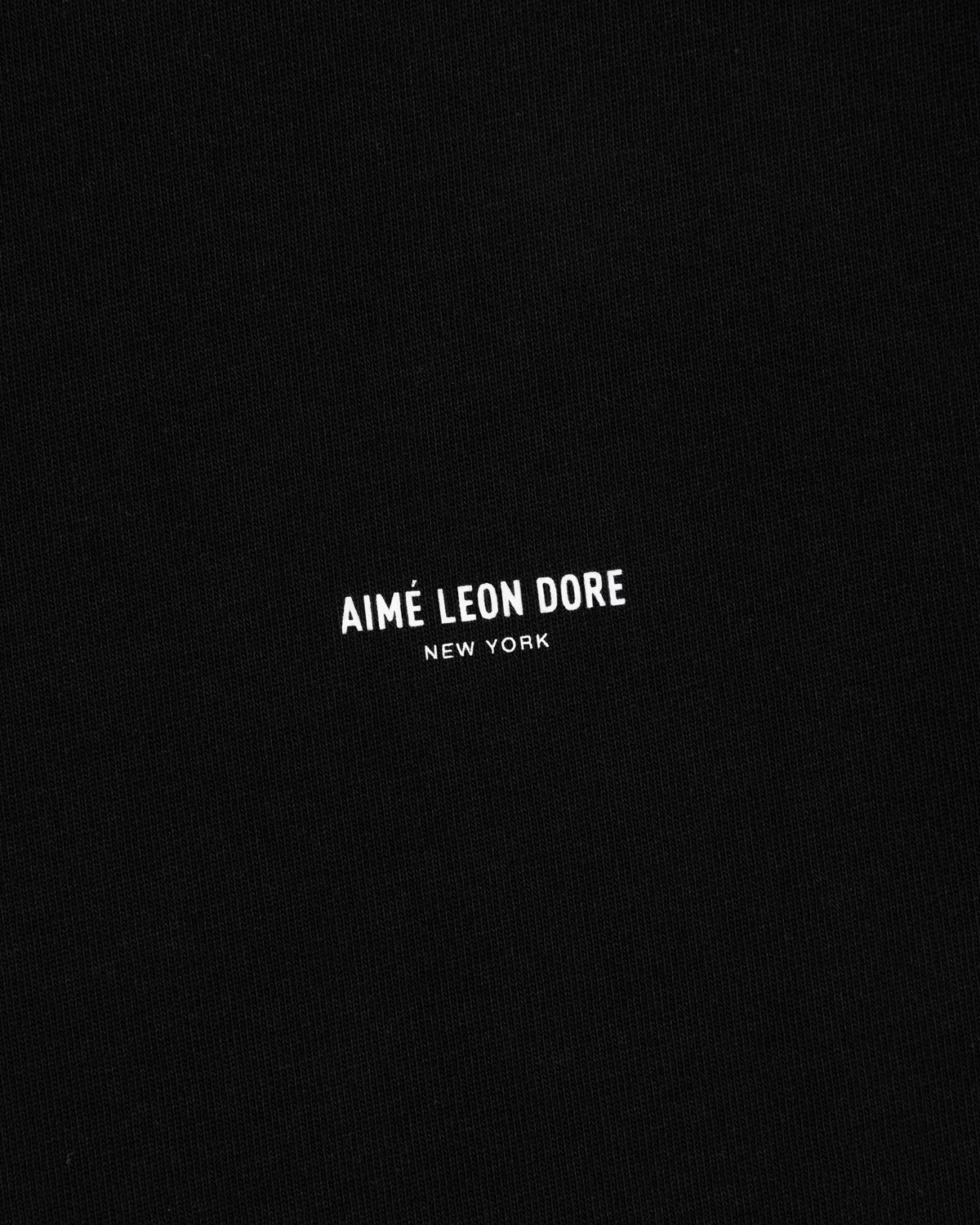 Black Long-Sleeve Micro Logo Tee with small white AIMÉ LEON DORE NEW YORK text centered.