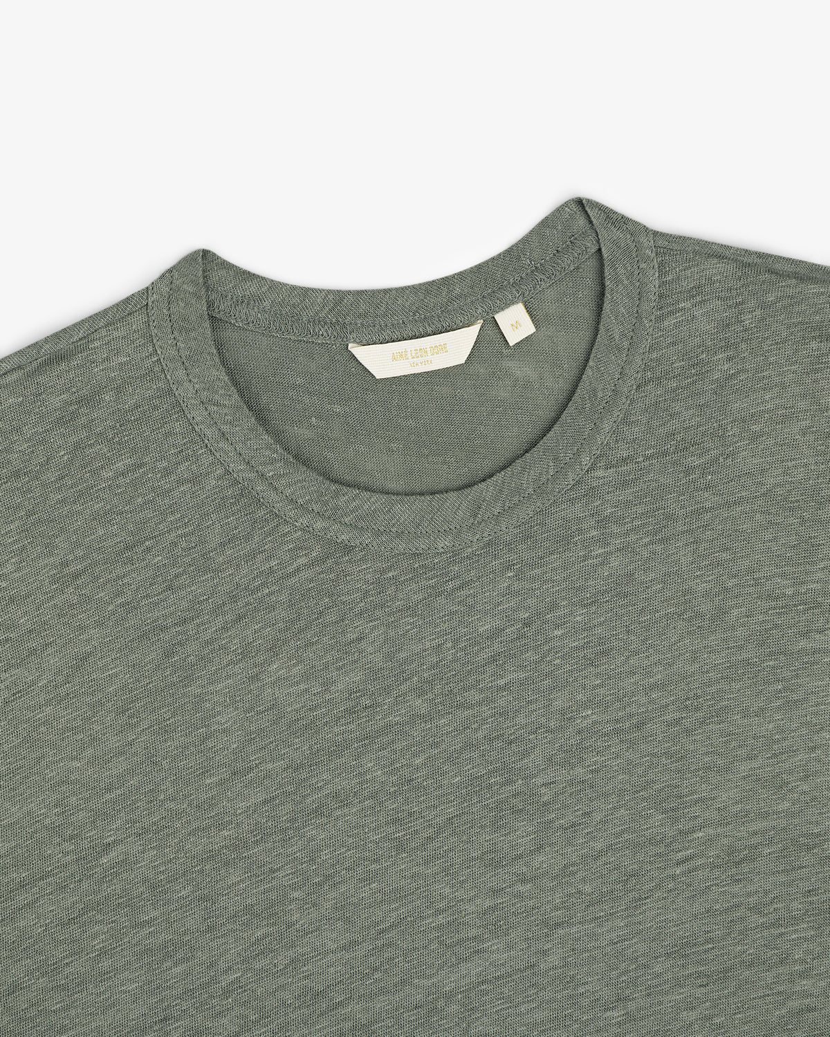 Linen Tee in grayish-green, crew neck style, laid flat to display the collar and inner label.