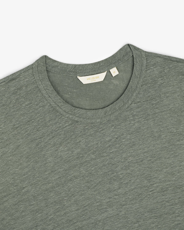 Linen Tee in grayish-green, crew neck style, laid flat to display the collar and inner label.