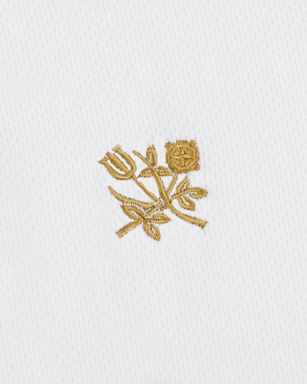 ALD / Technics Soccer Jersey featuring gold embroidered tulip and rose with leaves on white textured fabric.