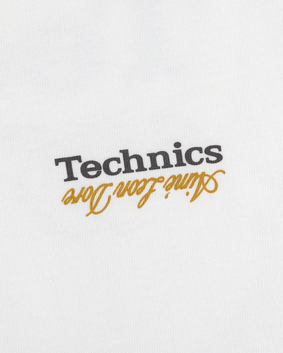 White ALD / Technics Logo Tee with black Technics text and gold Attitude from Long, both upside down.