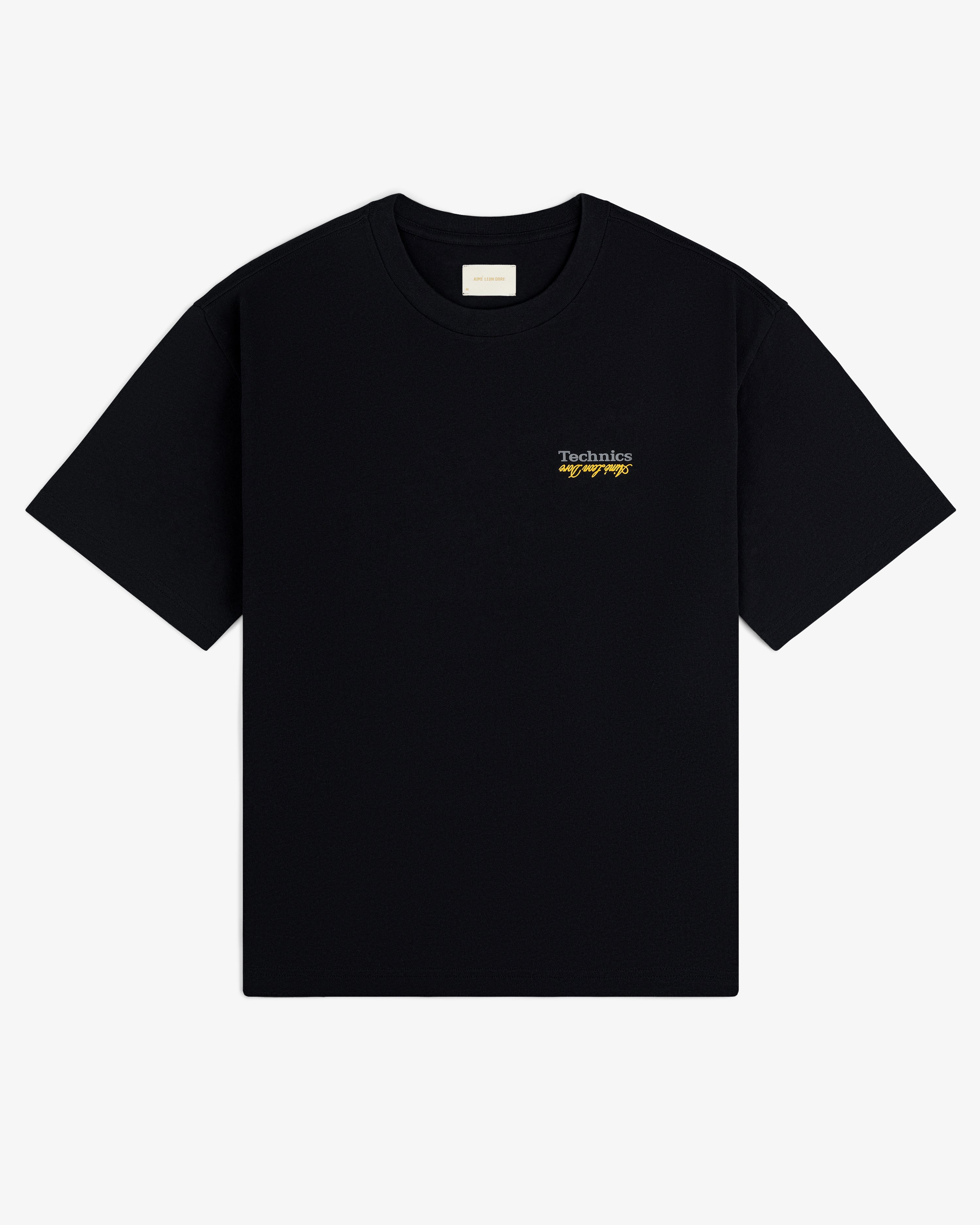 ALD / Technics Logo Tee: Black with small white and yellow "Technics by Design" text on the upper left chest.