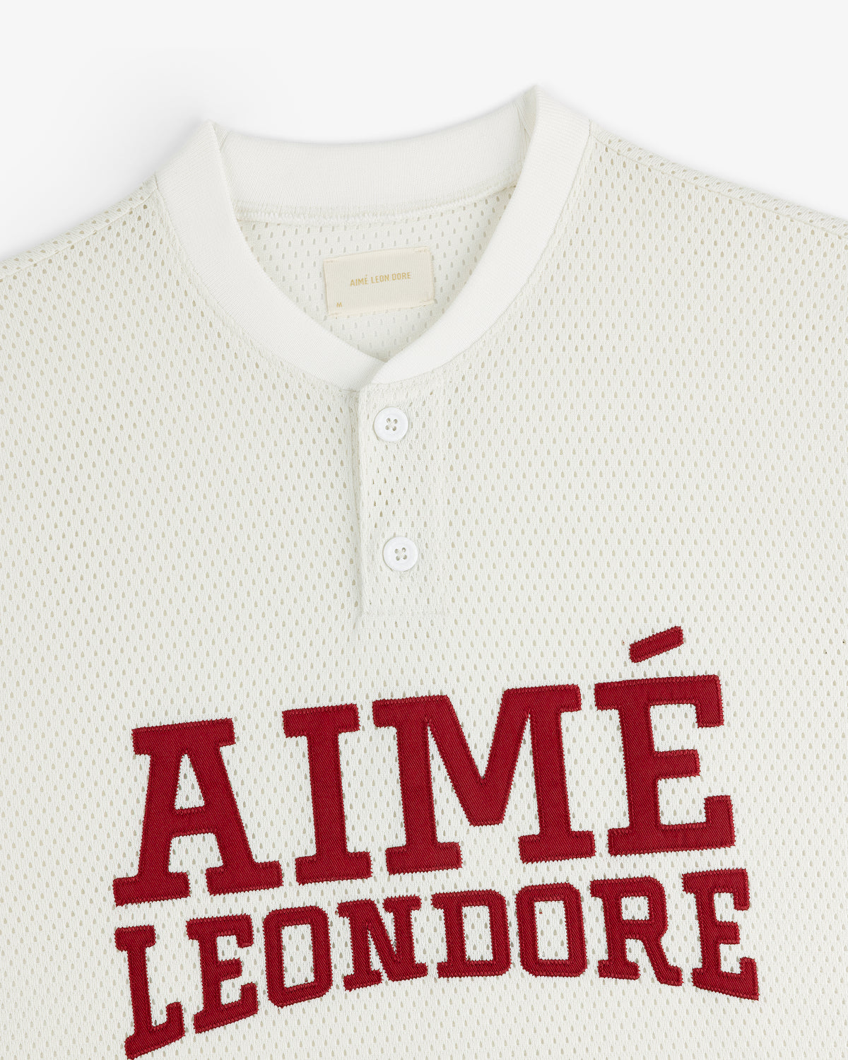 White Mesh Batting Practice Jersey with two buttons and AIMÉ LEON DORE in large red letters across the chest.