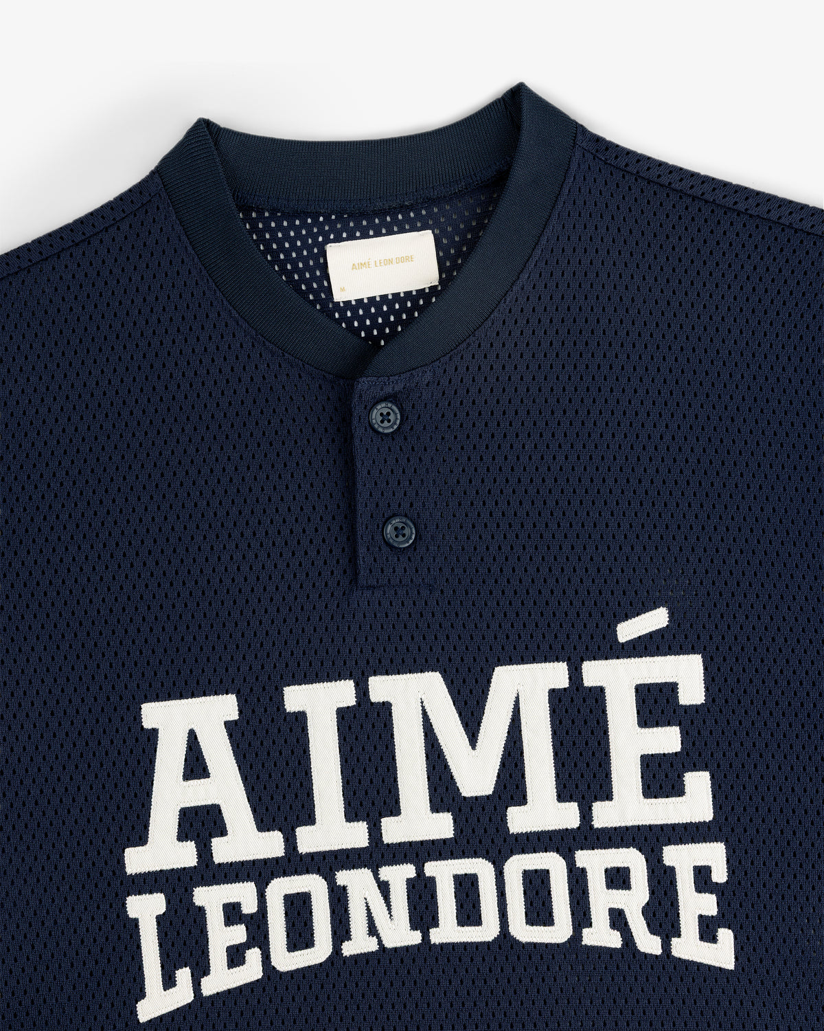Navy blue Mesh Batting Practice Jersey with AIMÉ LEON DORE in white and two buttons near the collar.