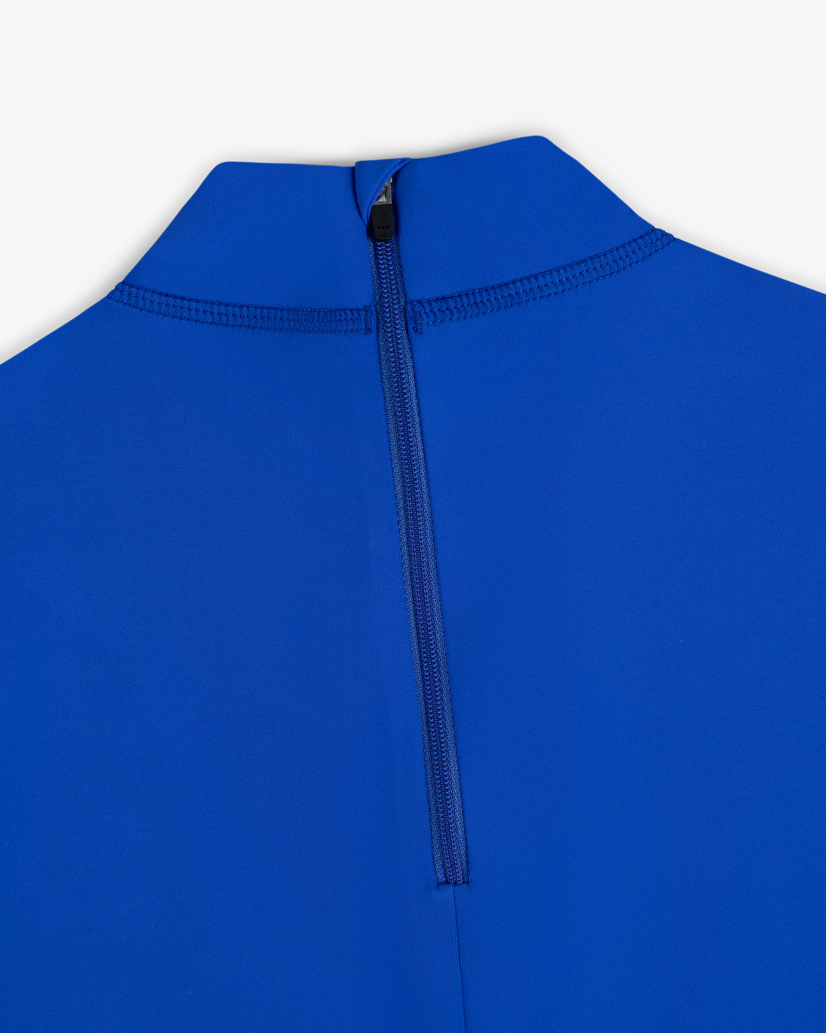 Close-up of the Short Sleeve Crest Rash Guard in blue with a black back zipper and high collar against a white background.