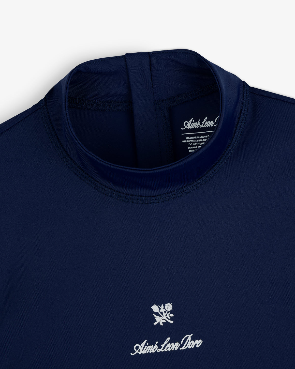 Navy blue Short Sleeve Crest Rash Guard by Aimé Leon Dore with a white logo and rose graphic below the collar.