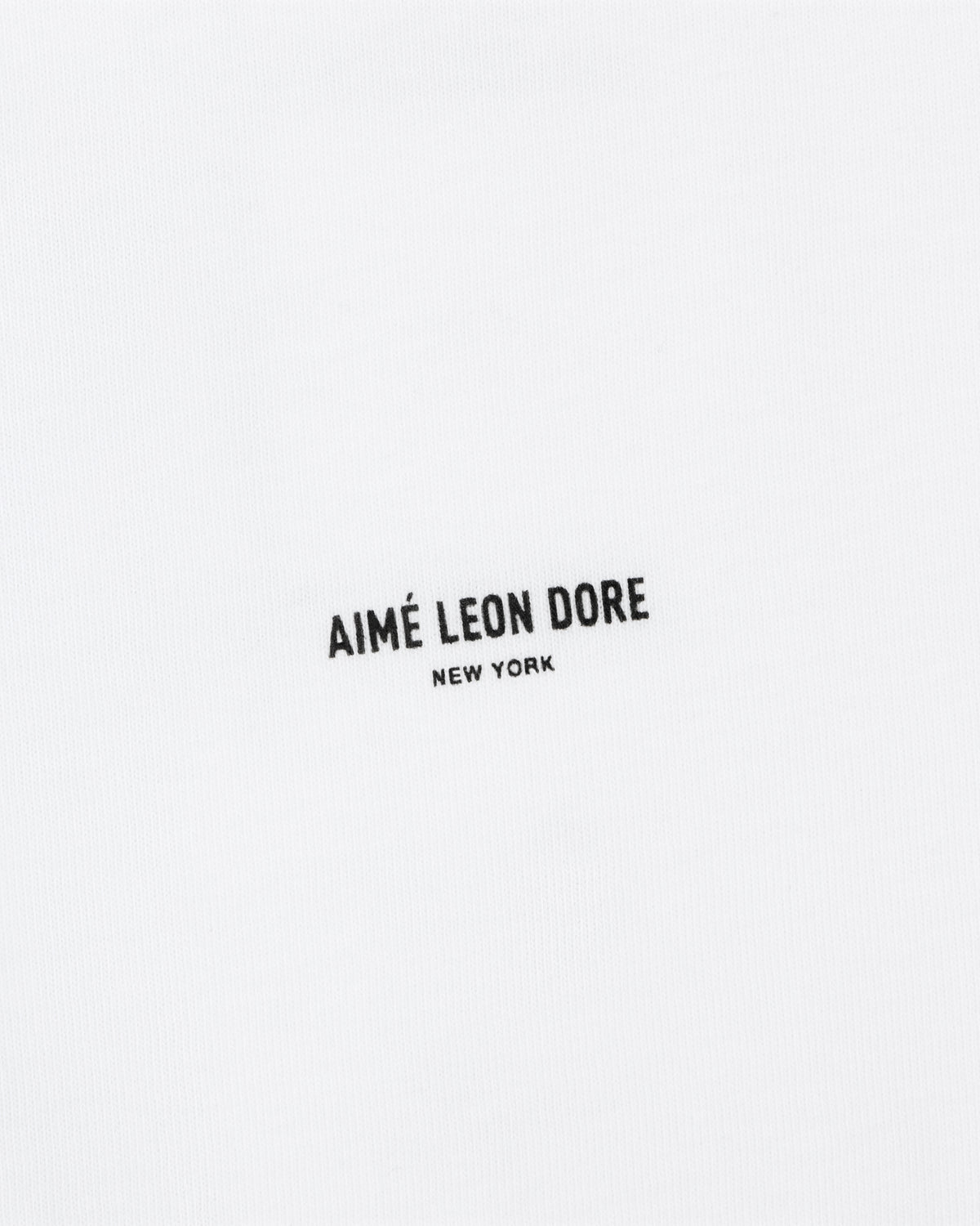 White Mott Street Tee with "AIMÉ LEON DORE NEW YORK" in small black uppercase letters at the center.