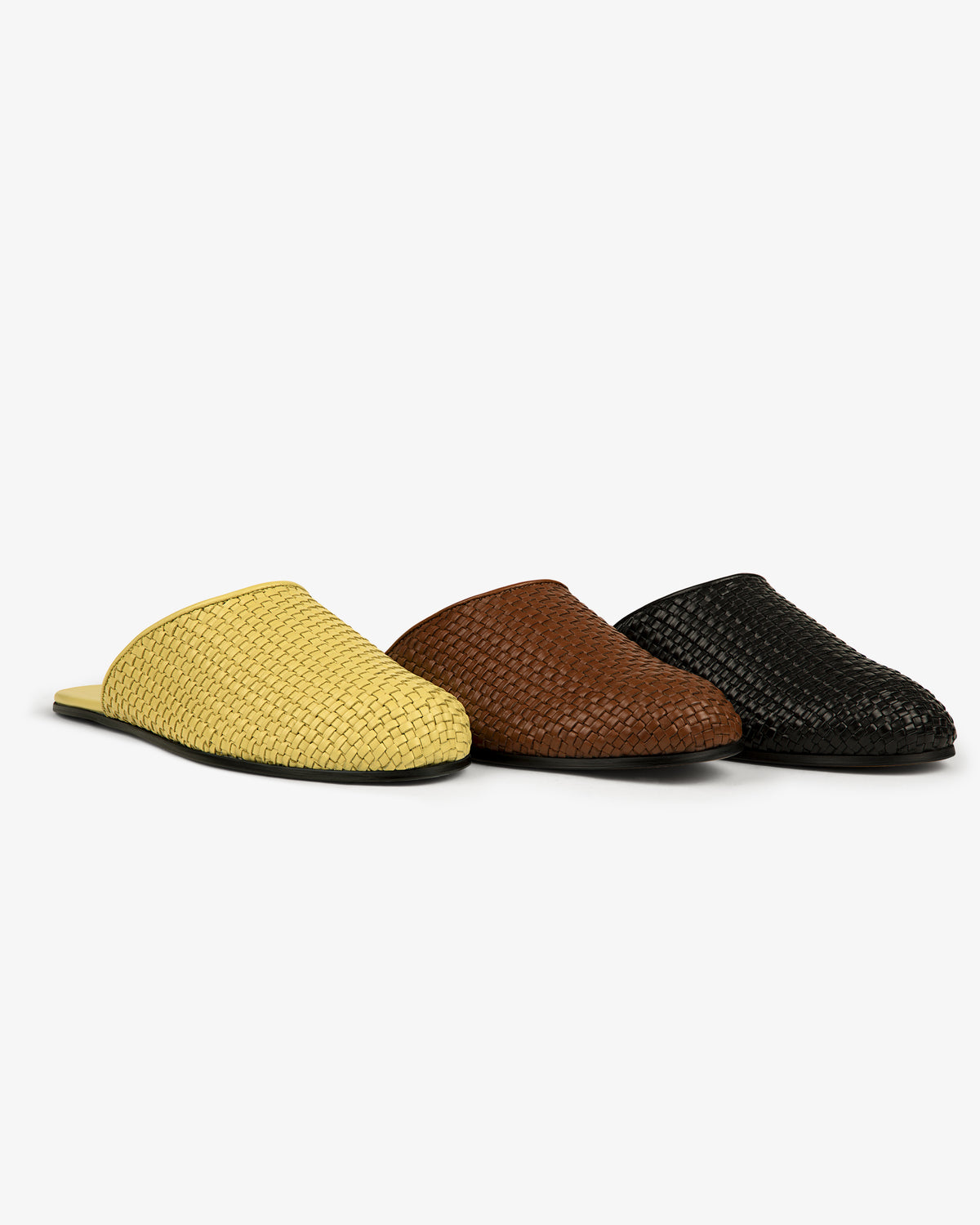 Three Leather Raffia Mule slip-ons in yellow, brown, and black are arranged side by side on a white background.