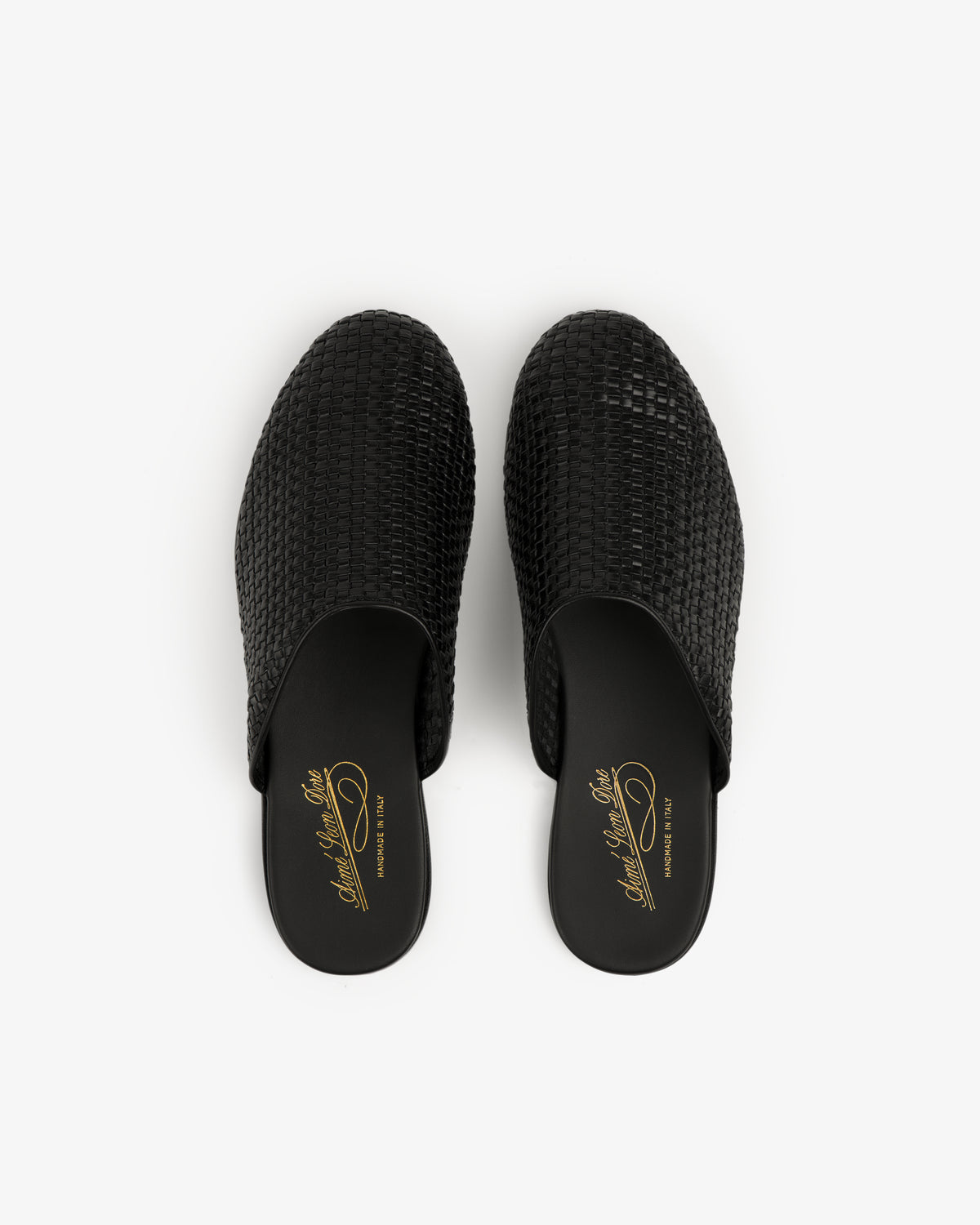 A pair of Leather Raffia Mule shoes with gold insole branding, shown on a white background.