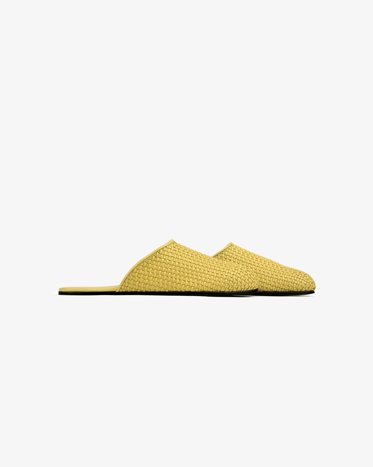 Leather Raffia Mule shown in side profile, yellow woven slip-on with flat sole on a plain white background.