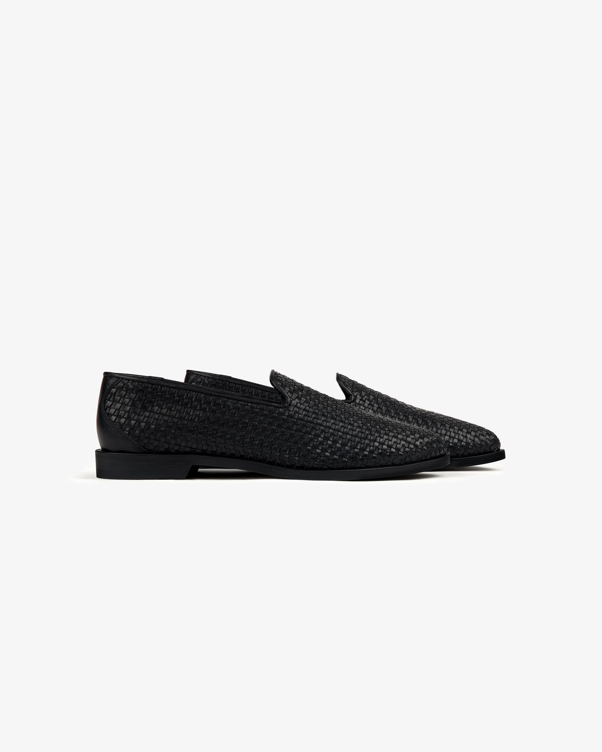 Leather Raffia Loafer with black woven leather, low heel, and rounded toes, shown in side profile on white background.