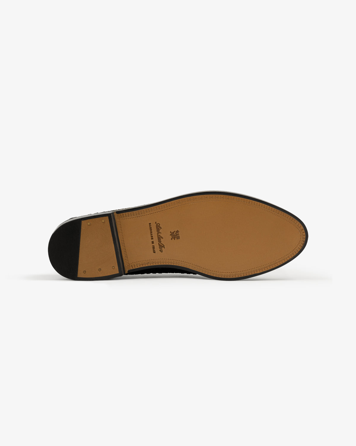 The image shows the sole of the Leather Raffia Loafer, featuring a tan leather bottom with stitching and a black heel.