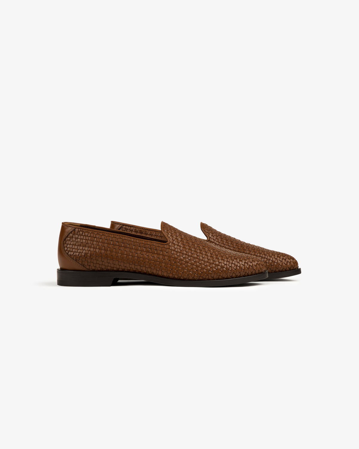Leather Raffia Loafer with brown woven leather and low heels, shown from the side on a white background.
