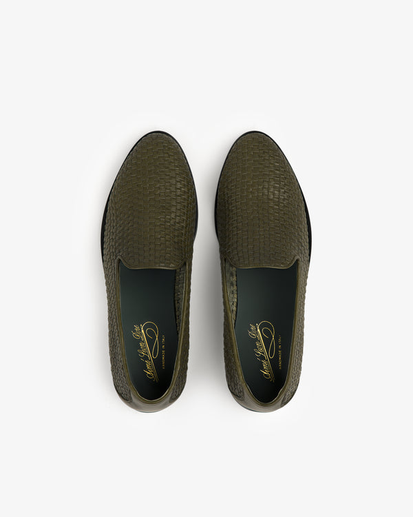Top view of a pair of Leather Raffia Loafers in olive green with woven texture and dark green insoles.