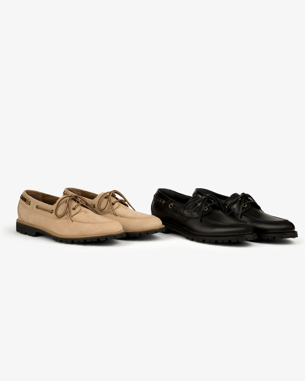 Two pairs of Pápia Boat Shoes—one beige, one black—side by side on a white background.