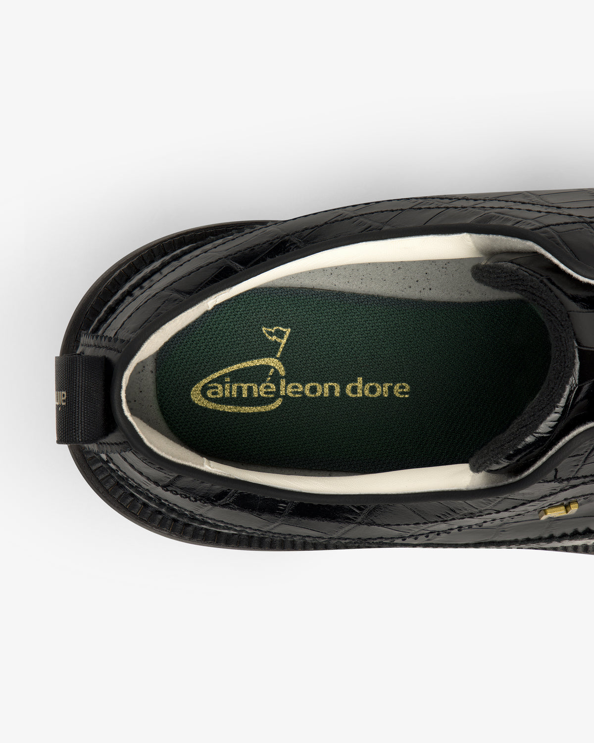 Top view of the ALD / Footjoy Croc-Embossed Premiere Series Marquis with a green insole and gold aimé leon dore text.