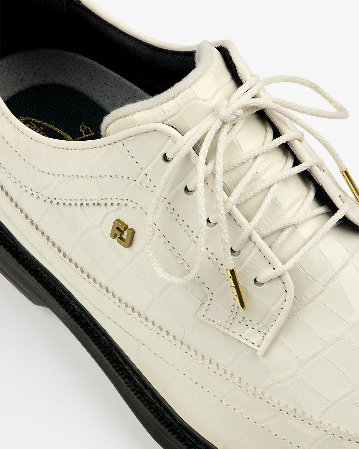 Close-up of ALD / Footjoy Croc-Embossed Premiere Series Marquis shoe with gold accents and black sole, top view.