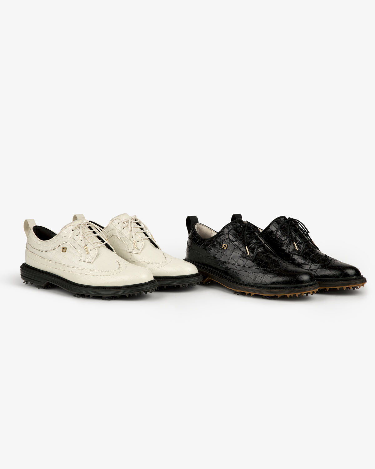 Two ALD / Footjoy Croc-Embossed Premiere Series Marquis golf shoes, one white and one black, side by side.