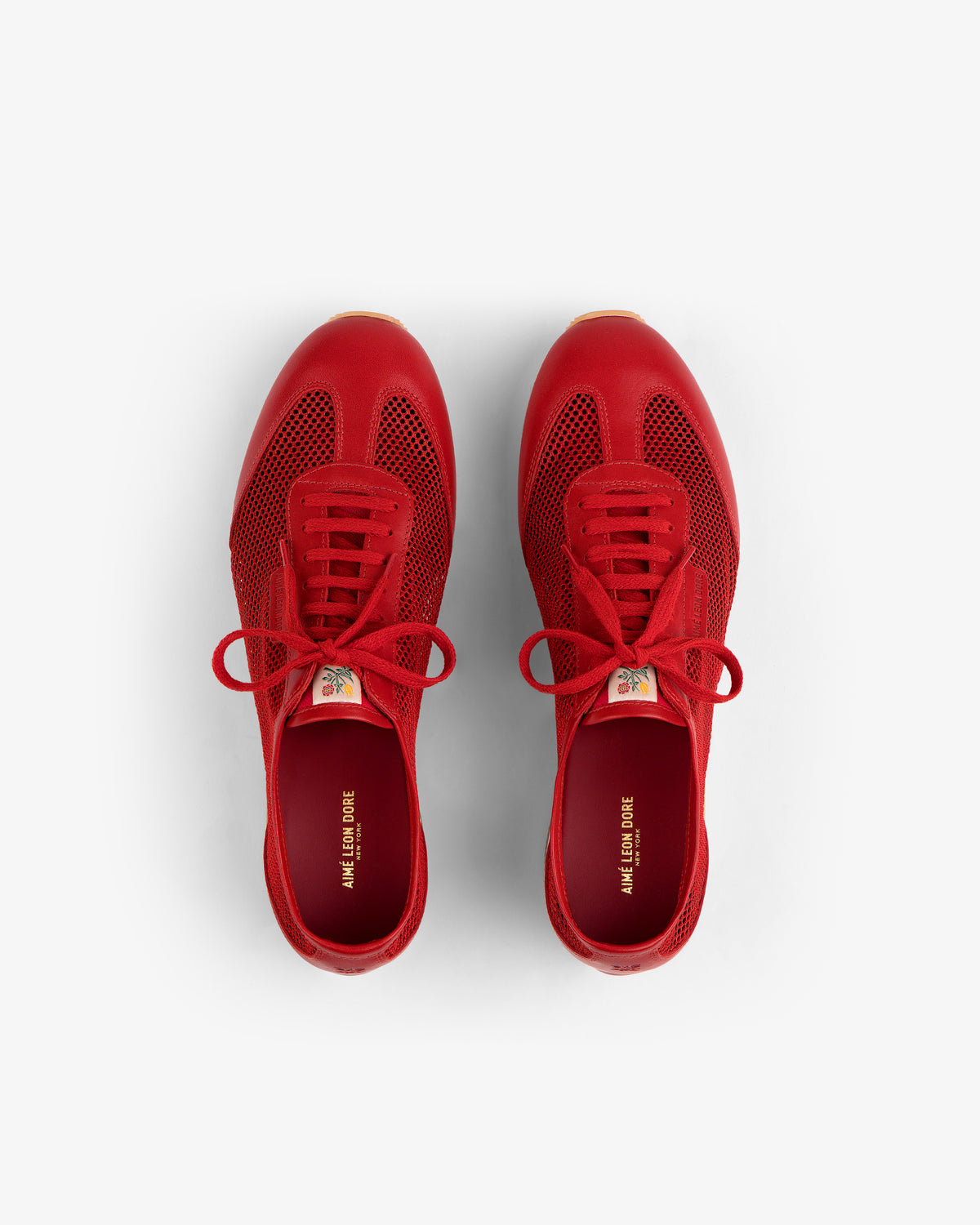 Low Profile Mesh Trainer in bright red, lace-up style, viewed from above on a white background.
