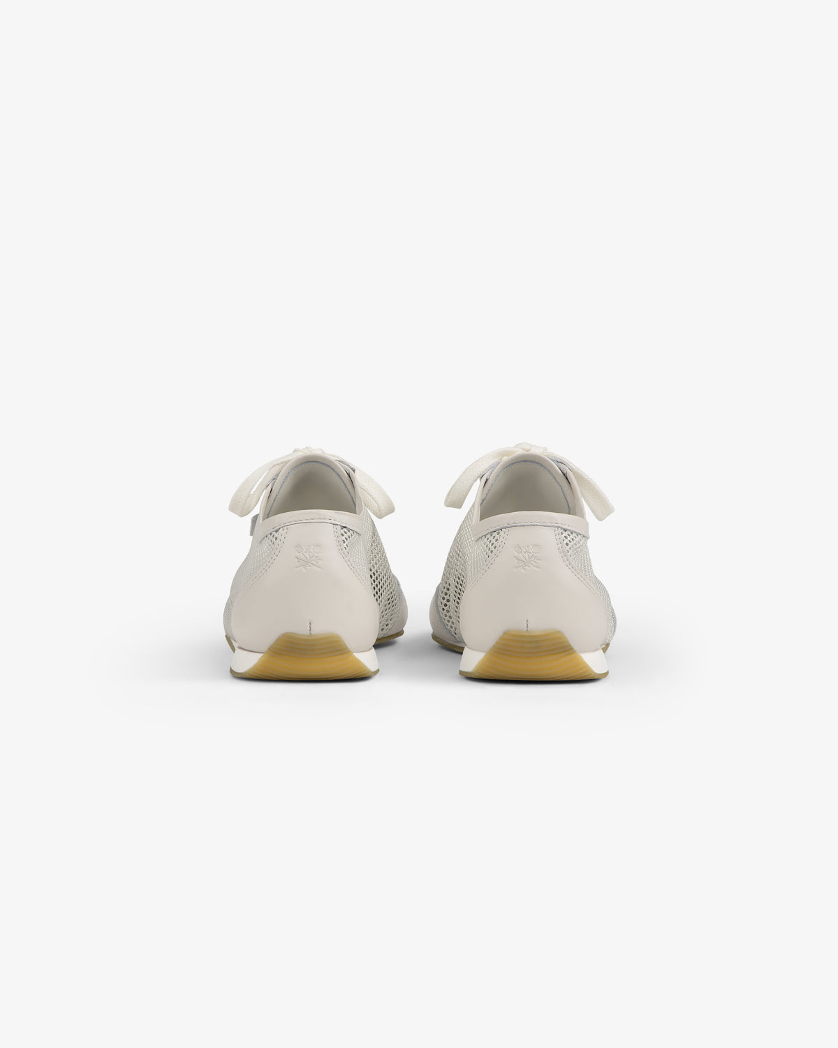 Rear view of Low Profile Mesh Trainer in white with yellow soles and ribbon-like heel details on a white background.