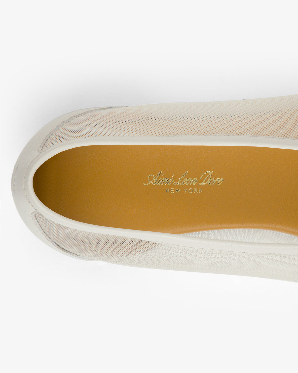 Top view of a beige Mesh Ballet Flat with gold Aimé Leon Dore New York branding on the insole.
